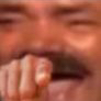 Man pointing his finger directly at the camera with a mischievous, laughing expression.