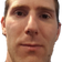 A man with a skeptical, judgmental facial expression looking directly at the camera.