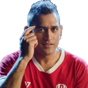 Mahendra Singh Dhoni tapping his temple with his finger while looking at the camera.