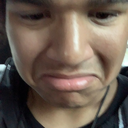 A man making a disgusted face with his lips pursed and eyes squinted.
