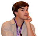 A man rests his chin on his hand while looking at the camera with a skeptical, knowing expression.