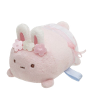 A small, round pink bunny plushie with white ears and flower decorations on its head.